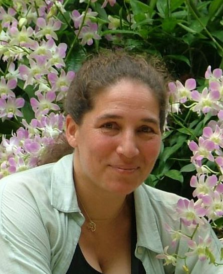 Kalia Kliban seated among pale purple flowers