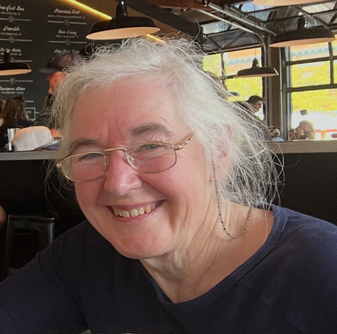 Mary Luckhardt smiling in a blue patterned scarf
